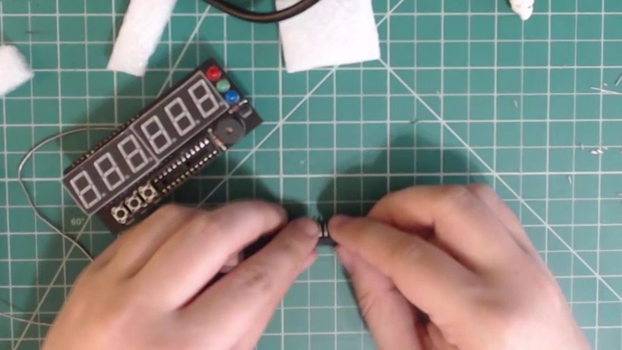 Gently bend the pins back to being straight. I do this by pressing the IC against my table.