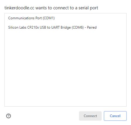 A browser dialog reads 'tinkerdoodle.cc wants to connect to a serial port' and lists 'Communications Port (COM1)' and 'Silicon Labs CP210x USB to UART Bridge (COM6) - Paired', with Connect and Cancel buttons.