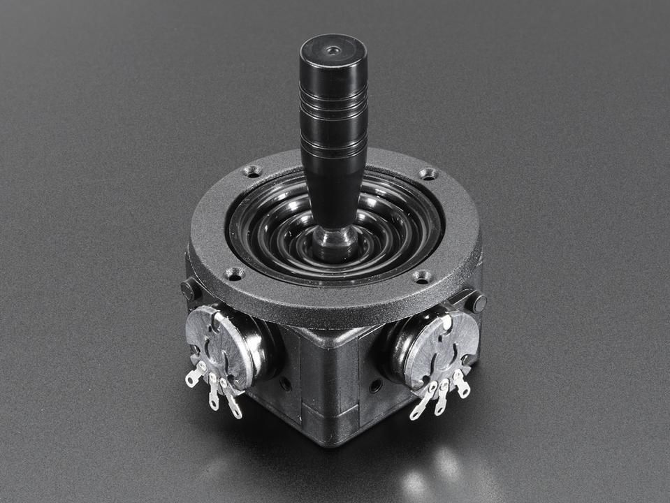 A black joystick with a tall ribbed handle on a round flanged base, with a potentiometer on each of two sides of its body to read the two axes.